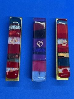 Stick on 3½ inch Gary Rosenthal Mezuzot. Small mosaic glass cases in the colors of the Kabbalah, silver(left), purple (center), and gold (right). RC25 $49.50 each.