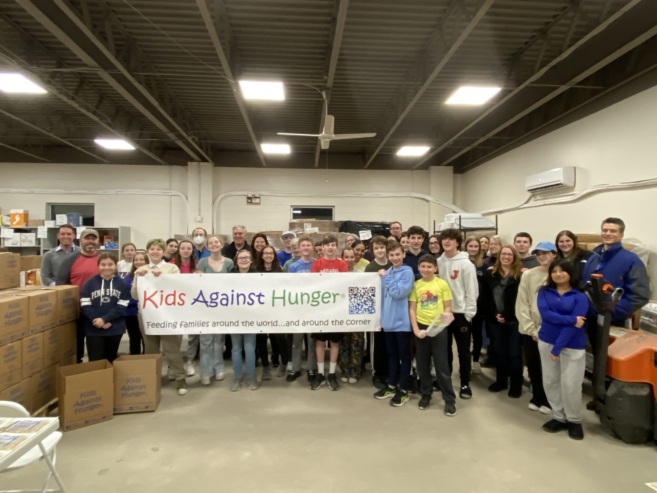 Our teens volunteering at Kids Against Hunger